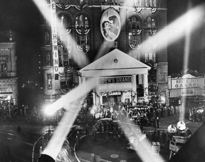View of the crowd, decorations, and search lights outside the Loew's Grand Theater on Peachtree Street in downtown Atlanta, Georgia, the night of the movie premiere of Gone With the Wind. Gone with the Wind was a Pulitzer Prize-winning novel written by Author Margaret Mitchell in 1936. The novel concerns a young woman's life in the midst of the Civil War and Reconstruction. In 1939 the book was made into a film, starring Vivien Leigh and Clark Gable. The film premiered in Atlanta, Georgia at Loew's Grand Theater.