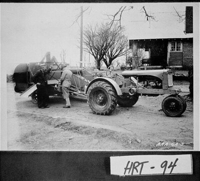 [Photograph of Allis-Chalmers all-crop harvester and tractor being sold to E. V. White at his farm, Hartwell, Hart County, Georgia, ca. 1940 ]
